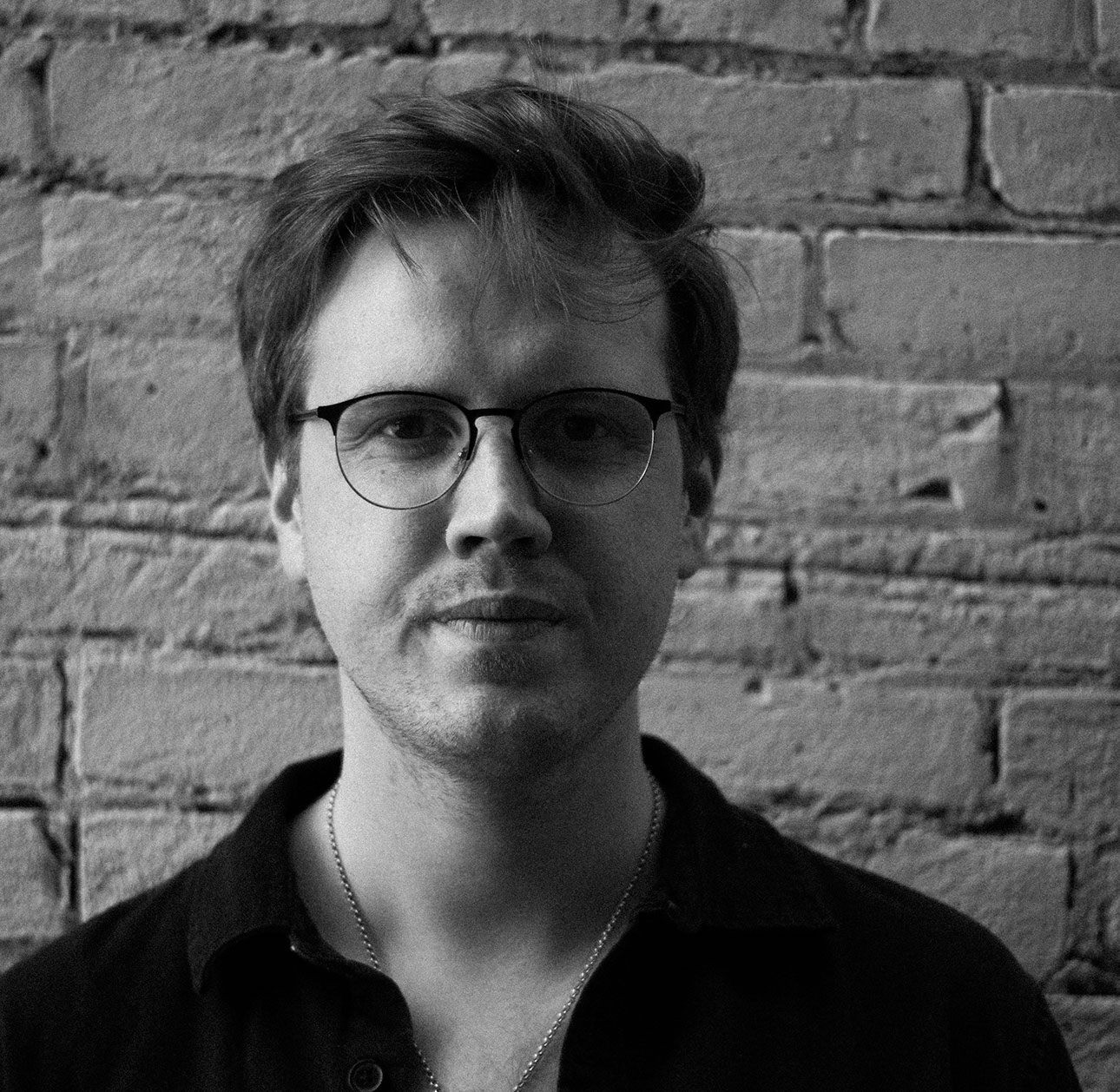 Addison Johnson, Founder of With Care Media. In a black and white photograph