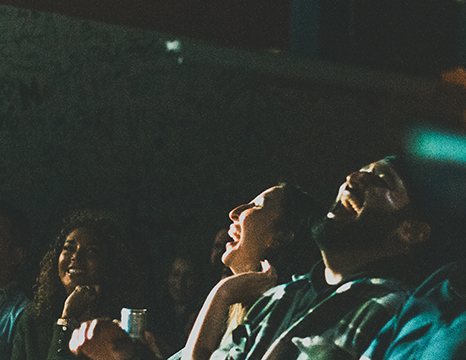 audience laughing at a comedy show.