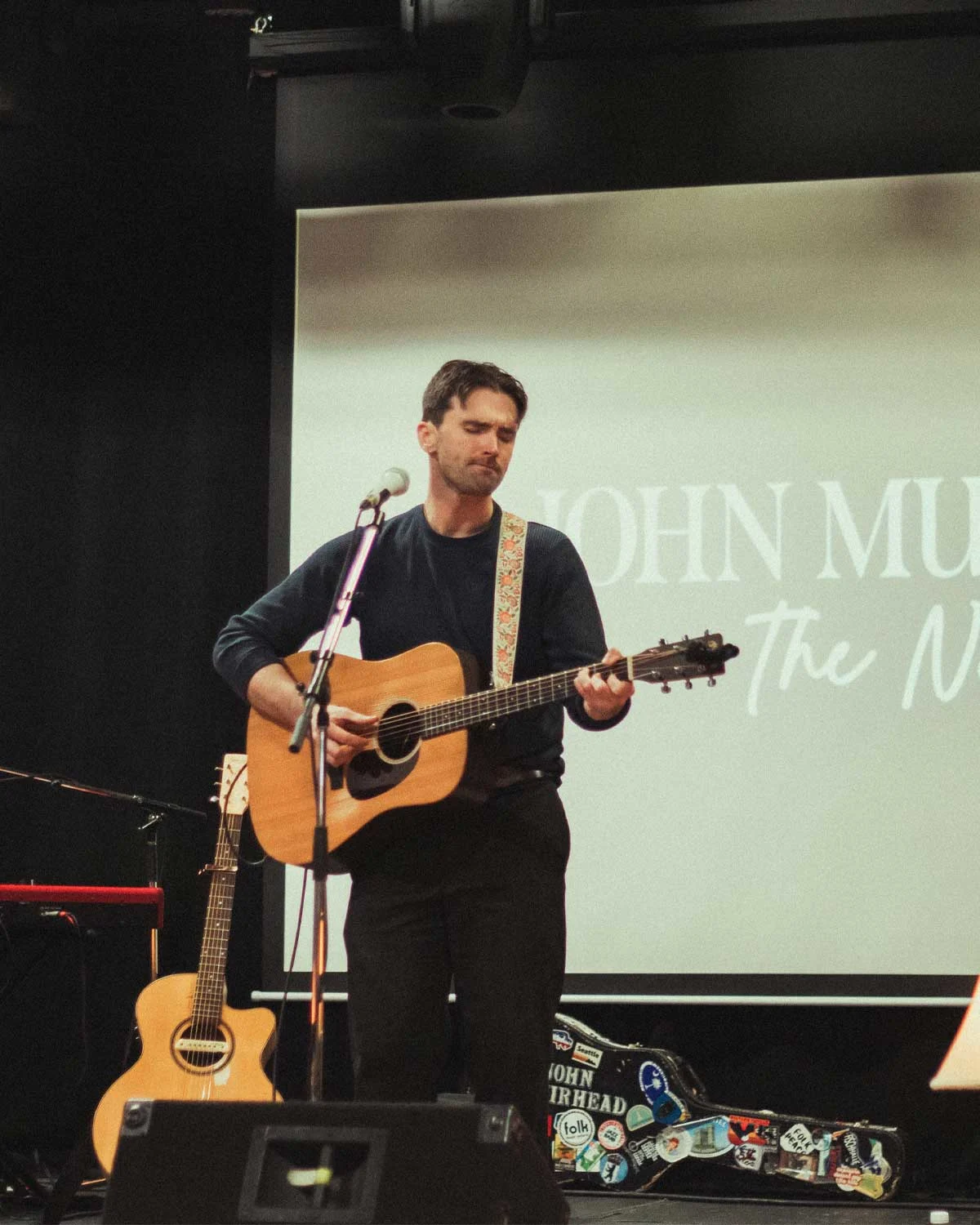 Artist John Muirhead performing live photo by Addison Johnson at With Care Media