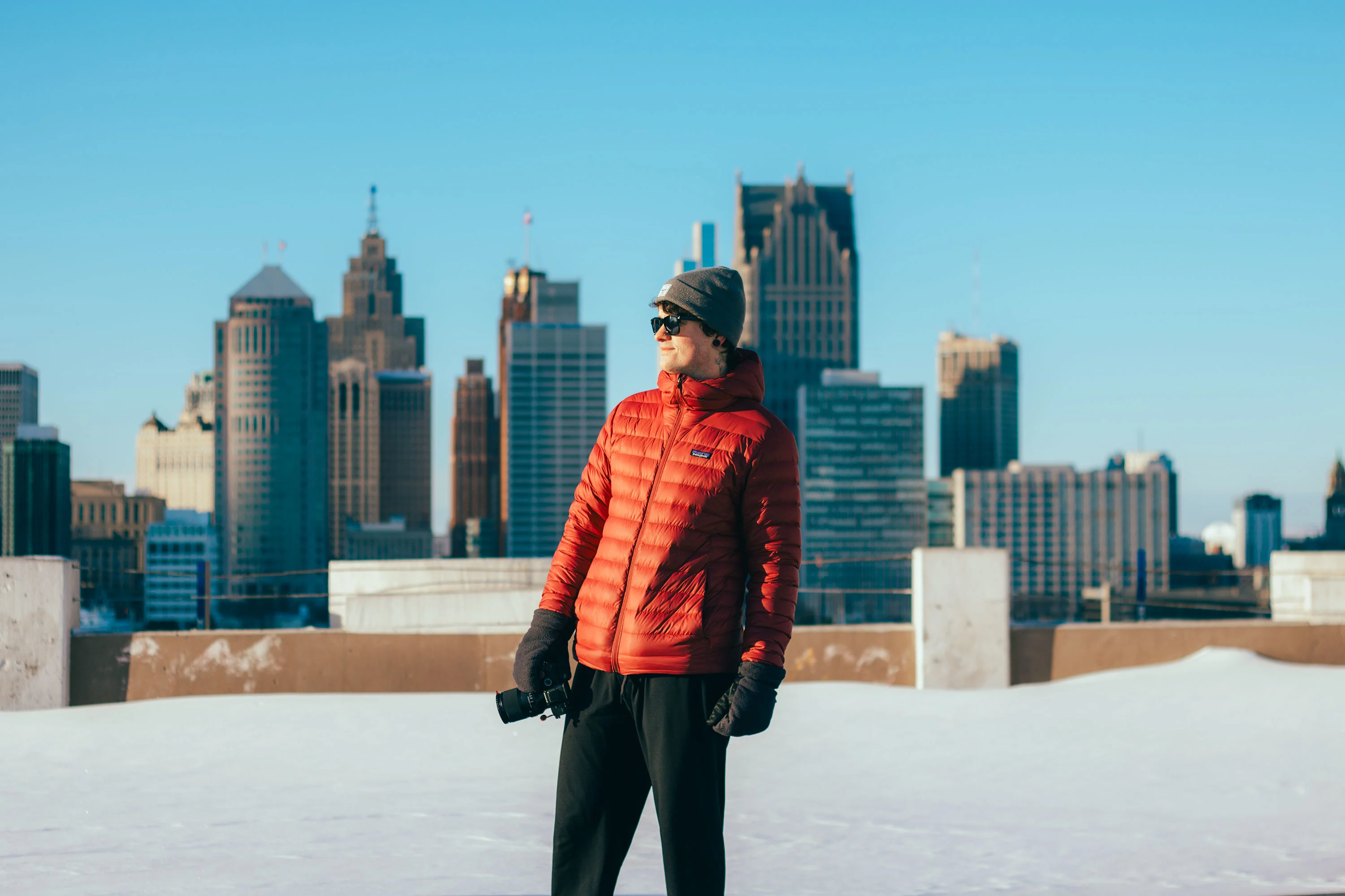 Man Standing on rooftop looking out to detroit