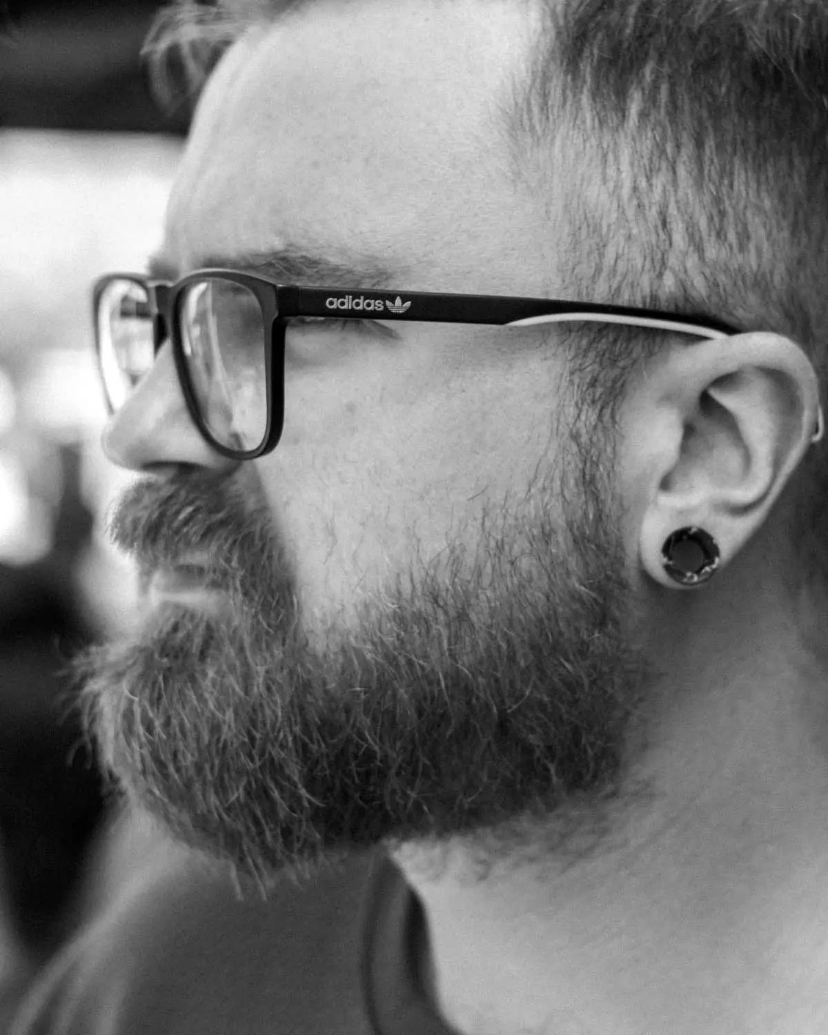 Man looking stoic in black and white image.