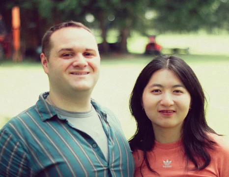 Couple smiling at camera on a summer day