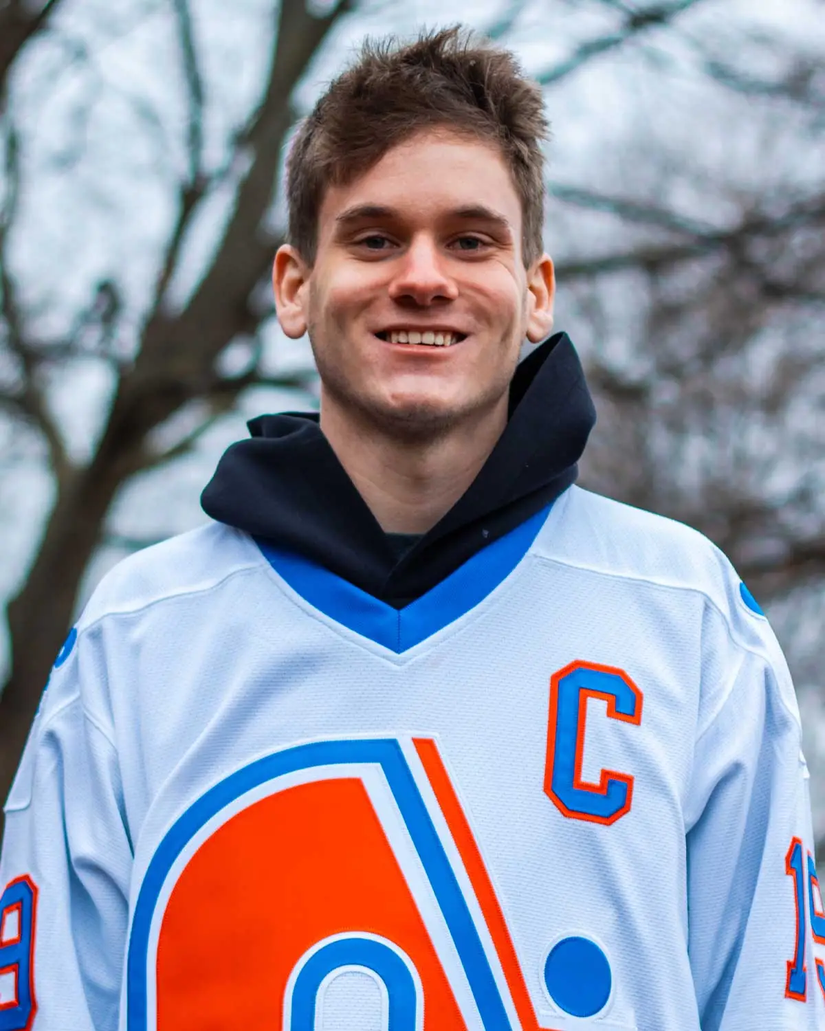 Man smiling during spring photoshoot.